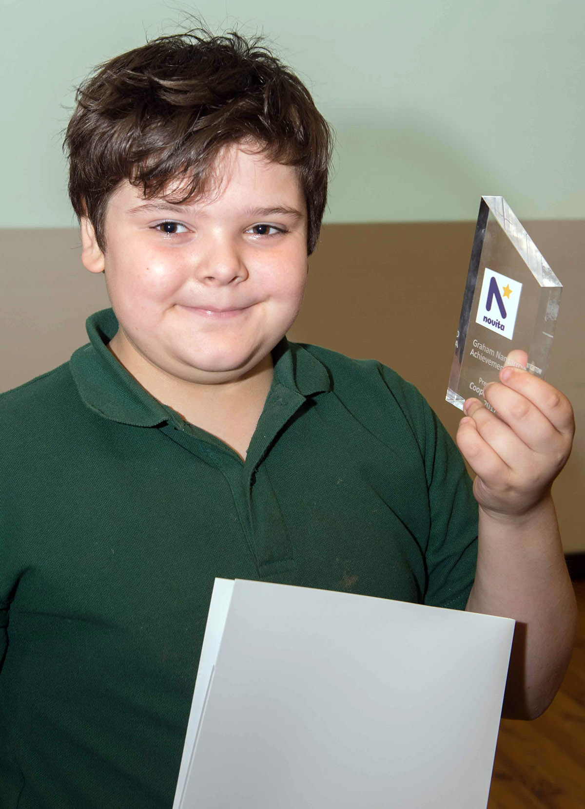 Cooper holding his award