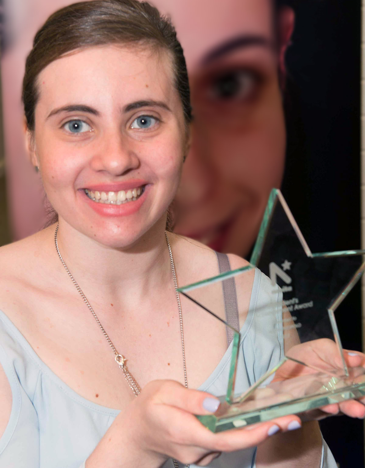 Photograph of Alyssa holding her award.