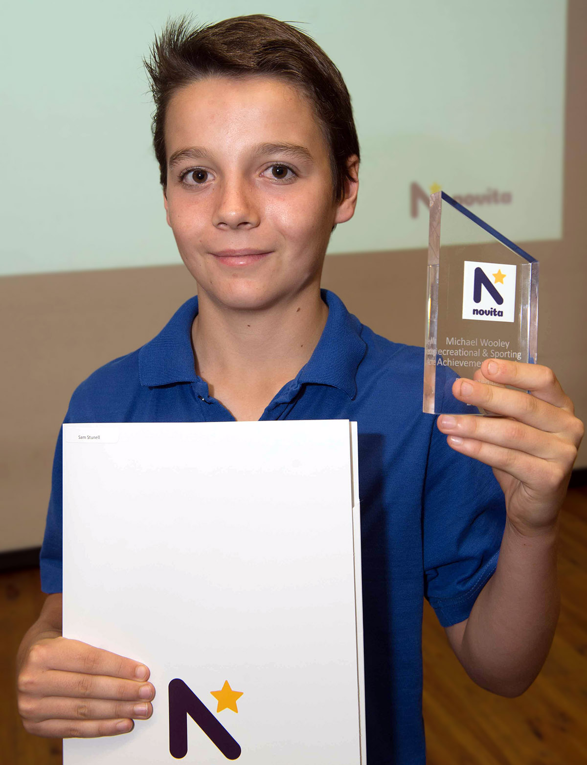 Sam holding his award