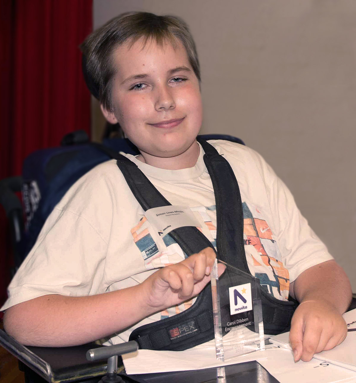 Photo of Simon holding his award.